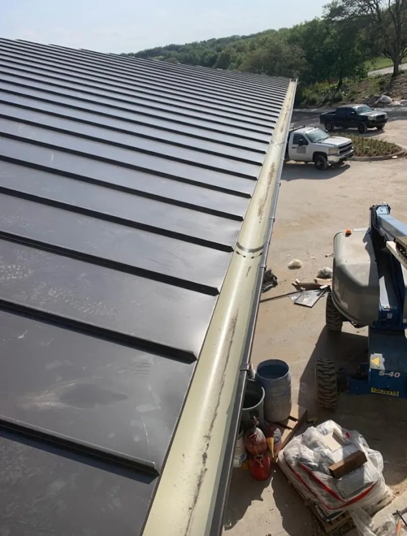 Standing seam panel and gutter detail on a metal roofing jobsite in Pittsburg